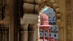 A view from inside a fort of the red cenotaph of Moosi Maharani Ki Chhatri.