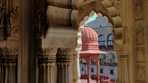 A view from inside a fort of the red cenotaph of Moosi Maharani Ki Chhatri