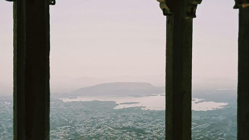 A view of a city in Rajasthan as seen from a top a haveli with a lake in view