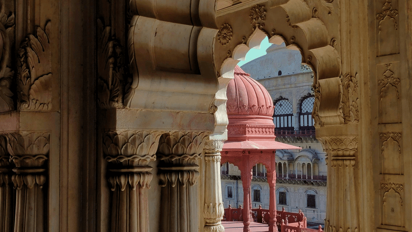 A view from inside a fort of the red cenotaph of Moosi Maharani Ki Chhatri