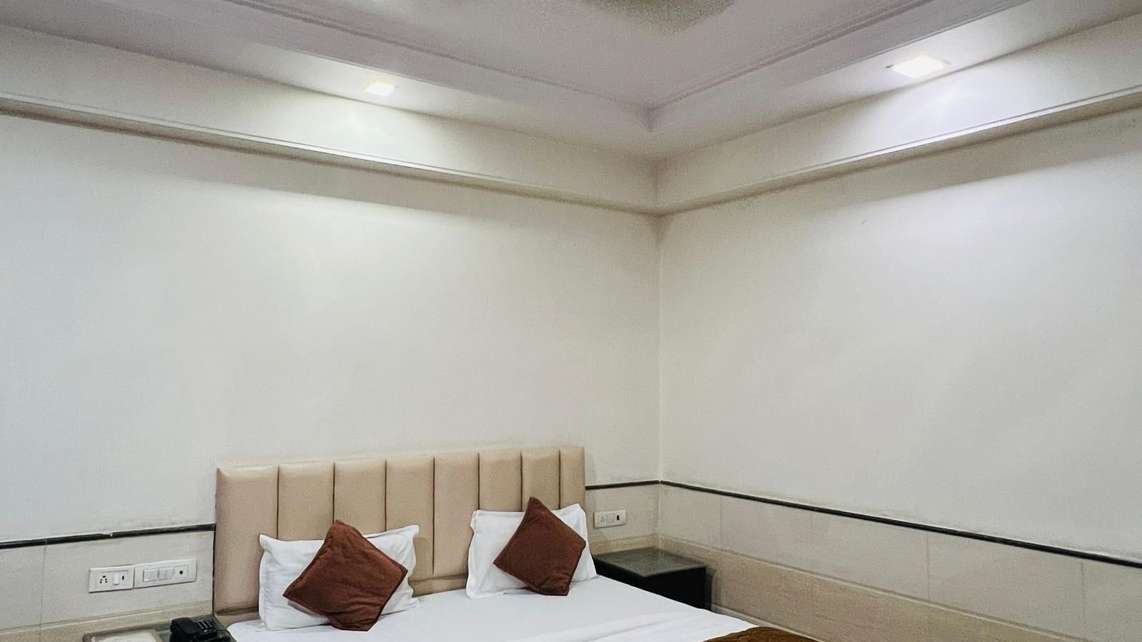 A spacious hotel suite with a sofa seating area, a private entrance, and elegant decor, providing a relaxing retreat. | Suite | Hotel Aadhar