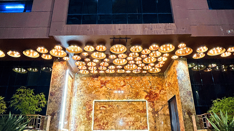 Night view of banquet hall entrance with marble steps and decorative lights at Infiniti Hotel, Indore.