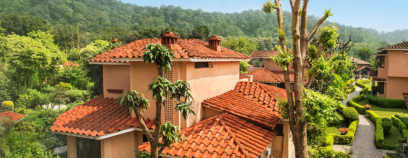 An image of a villa with many rooms and cottages amidst the trees - The Riverview Retreat,  Corbett