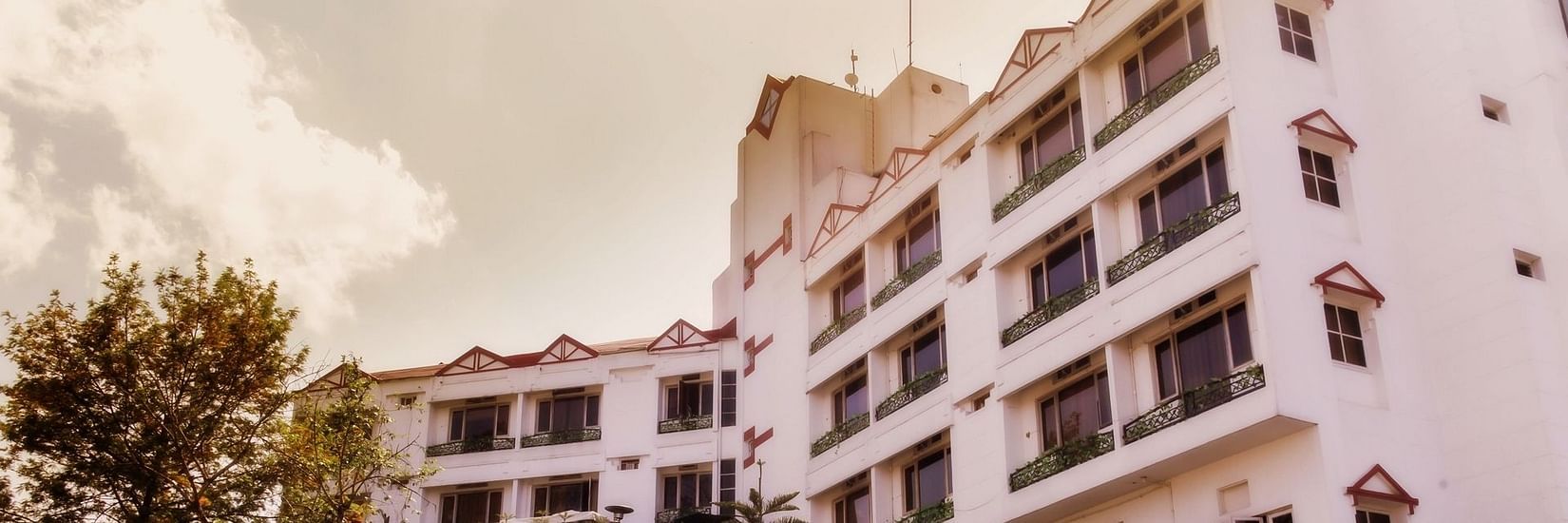 the exterior facade with white clouds in the background - Polo Towers hotel in Shillong