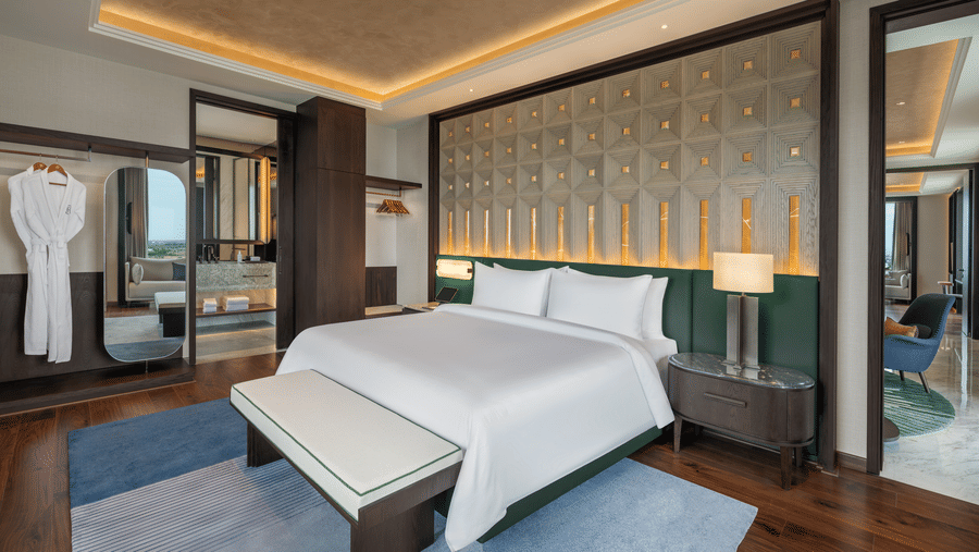 Executive Suite Room 8027 Bedroom 2 with a bed and warm ambient lighting at The Residency Signature Madurai.