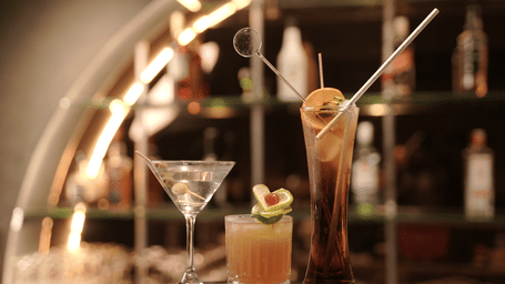 Assortment of handcrafted cocktails served at Trino Bar with stylish glassware