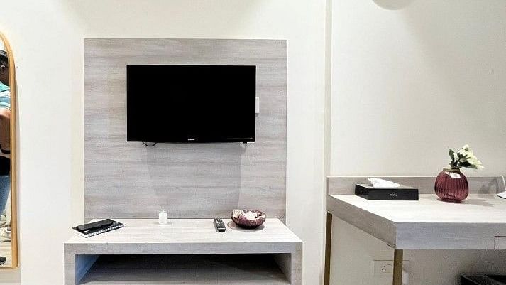 Image of a room with television and a table beside it.