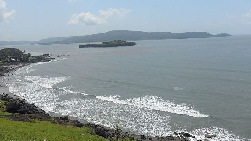 A scenic view of the Murud beach with greenery on one side of the coast