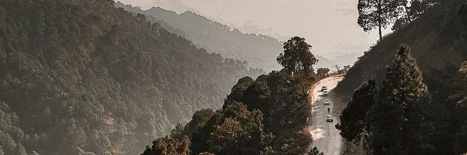 a narrow road going through the hills of Kasauli
