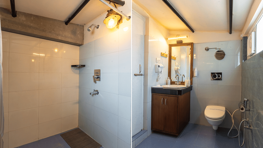 Contemporary bathroom with industrial-style lighting, dark wood accents, and a walk-in shower at Maati Resort By The Lake Hill, Jeolikote.