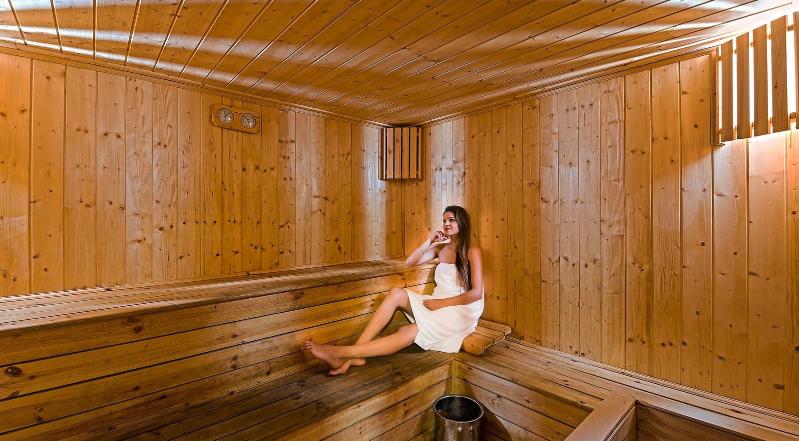 A lady sitting in the sauna at Nirvana Luxury Hotel, Ludhiana