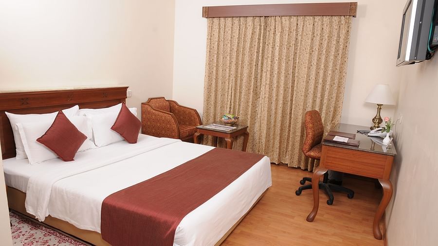 overview of a bedroom at Deluxe Room at Raj Park Hotel, Chennai