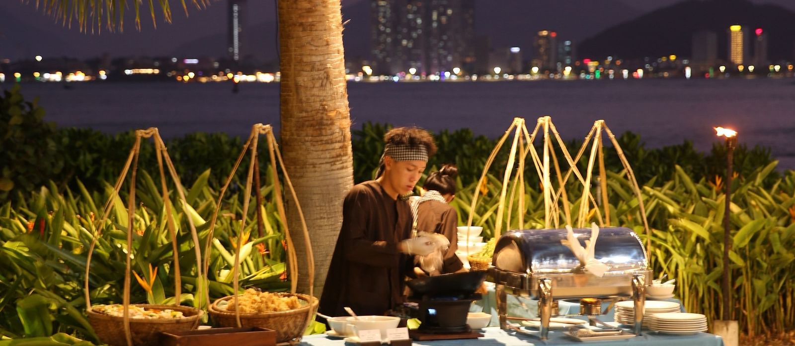 a person behind a mini buffet spread at Alibu Resort Nha Trang