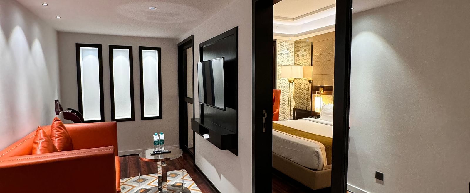A living space with wooden flooring and comfortable seating at Cenneys Gateway.
