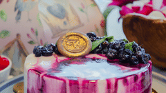 A close up shot of a table with a cake kept on it - Karma Lakelands.