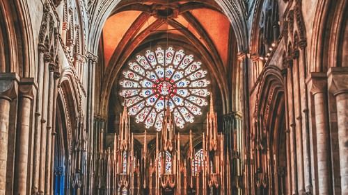 An overview of a cathedral with stained windows and gothic architecture