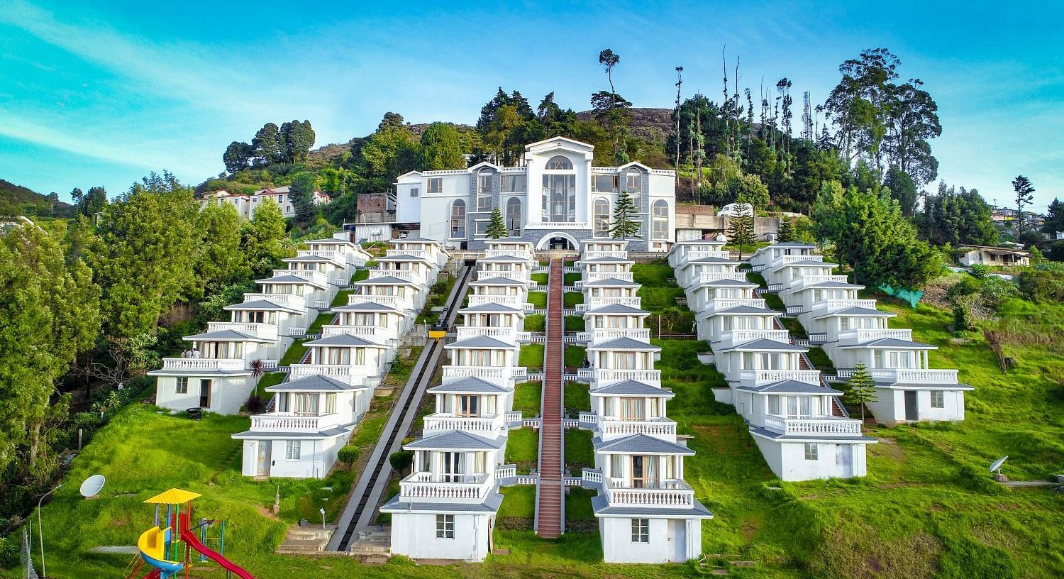 Exterior of a hotel on a hillside during the day