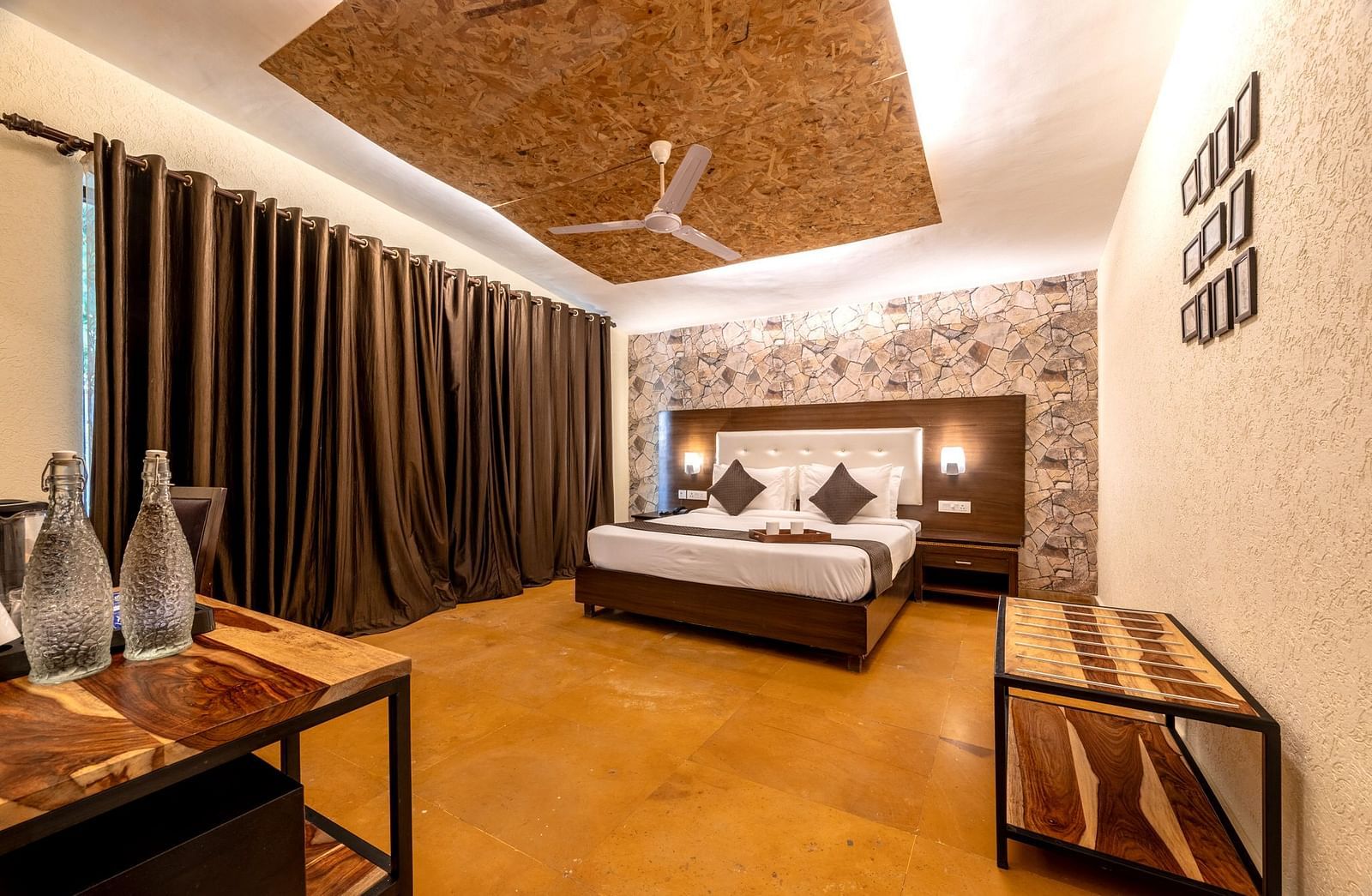 A room featuring a bed with lamps attached to the headboard on both sides at Valley by Grassfield.