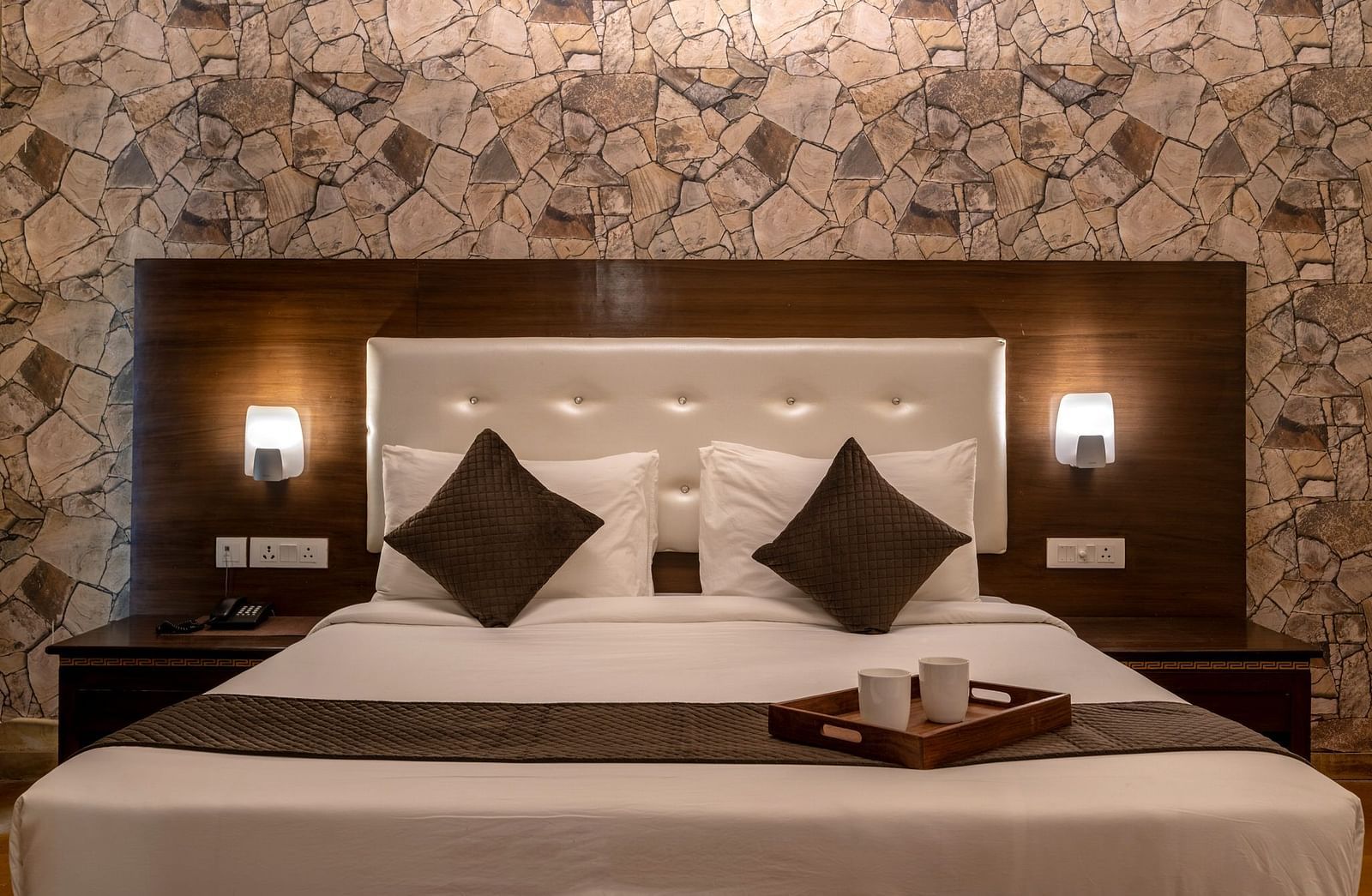 A bed with with lamps attached to the headboard on both sides at Valley by Grassfield.