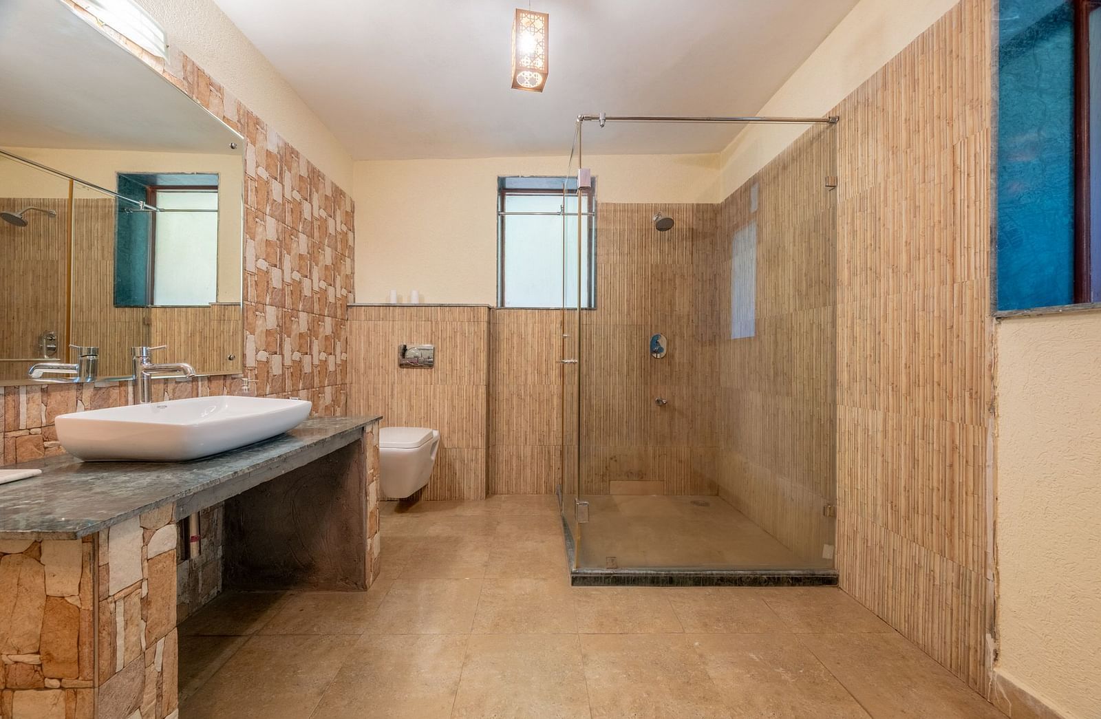 A washroom at Valley by Grassfield featuring a sink on the side and a separate shower cubicle in the corner.