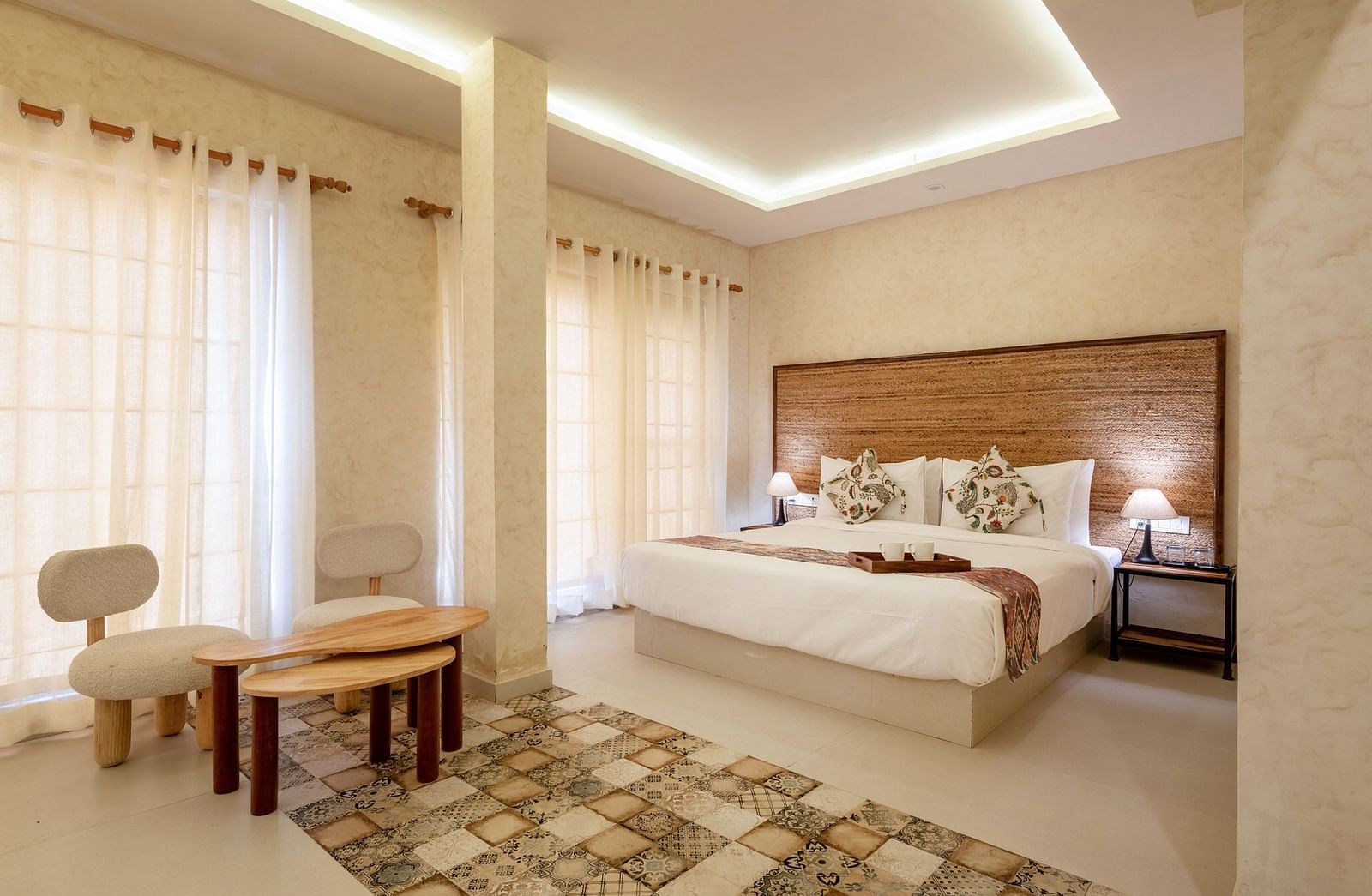 A room with a bed and a seating area in front at Valley by Grassfield.