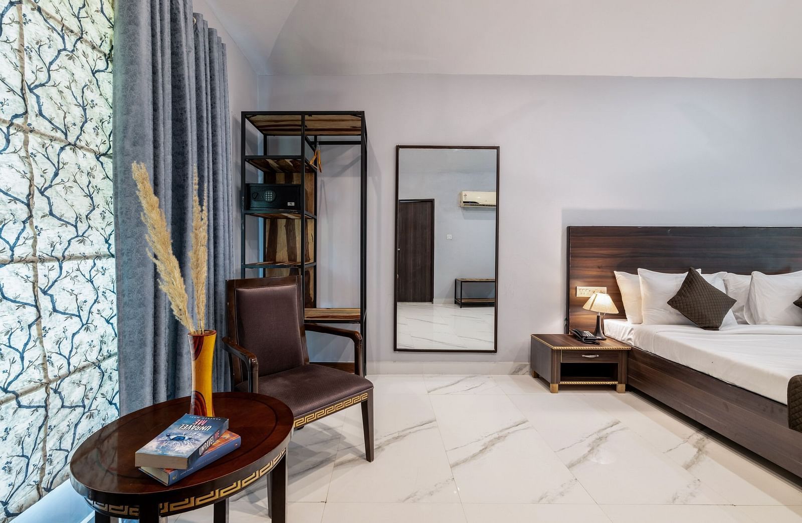 A room with a bed and a large mirror beside it at Valley by Grassfield.