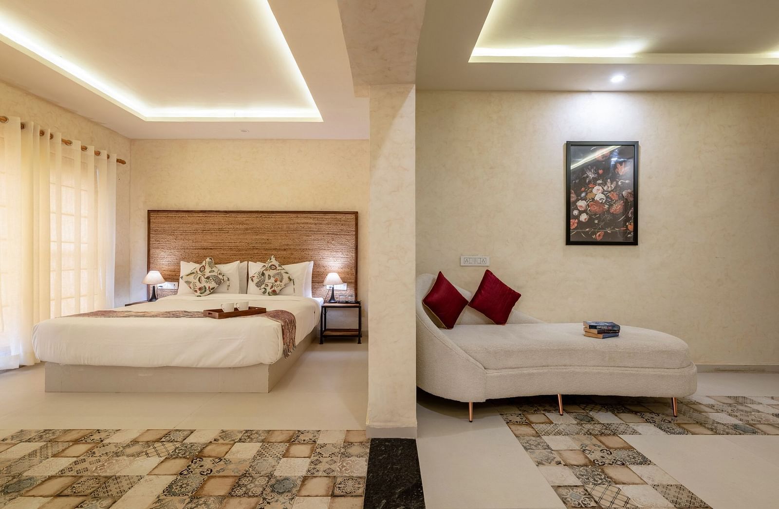 Front view of a bed and a sofa, separated by a half-wall, at Valley by Grassfield.