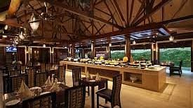The interiors of Oasis, our multi-cuisine restaurant in Pushkar with tables and chairs and a buffet table 