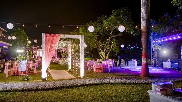 alt-text Festive entrance with fairy lights and floral arrangements.