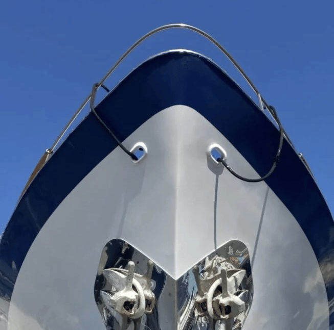Front view of the shiny hull of the Dreamcatcher cruise with a clear blue sky in the background.