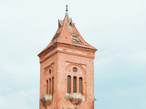 A red brick building with a clocktower in chennai.