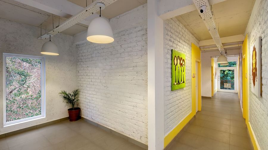 White, minimalist hostel room with colorful accents.