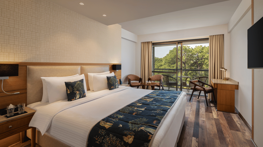 Superior Room at Infinitea Centric, Dharamshala with a double bed, television and a balcony