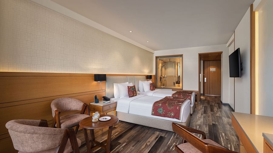 Premium peaks room with a double bed, chairs and a television