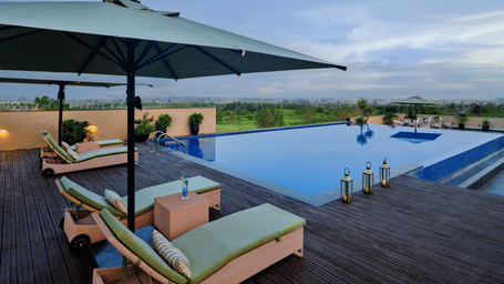 A beautiful outdoor pool with sun loungers and umbrellas, perfect for relaxing and enjoying the sunshine.