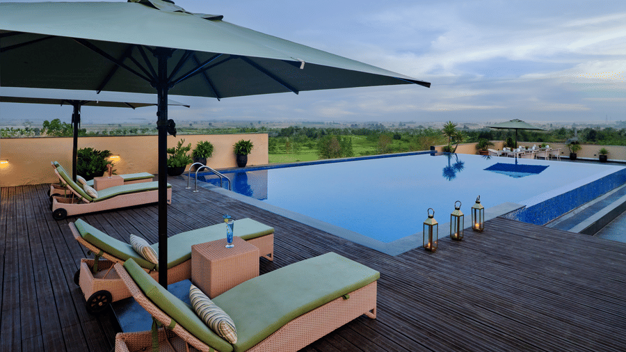 A beautiful outdoor pool with sun loungers and umbrellas, perfect for relaxing and enjoying the sunshine.