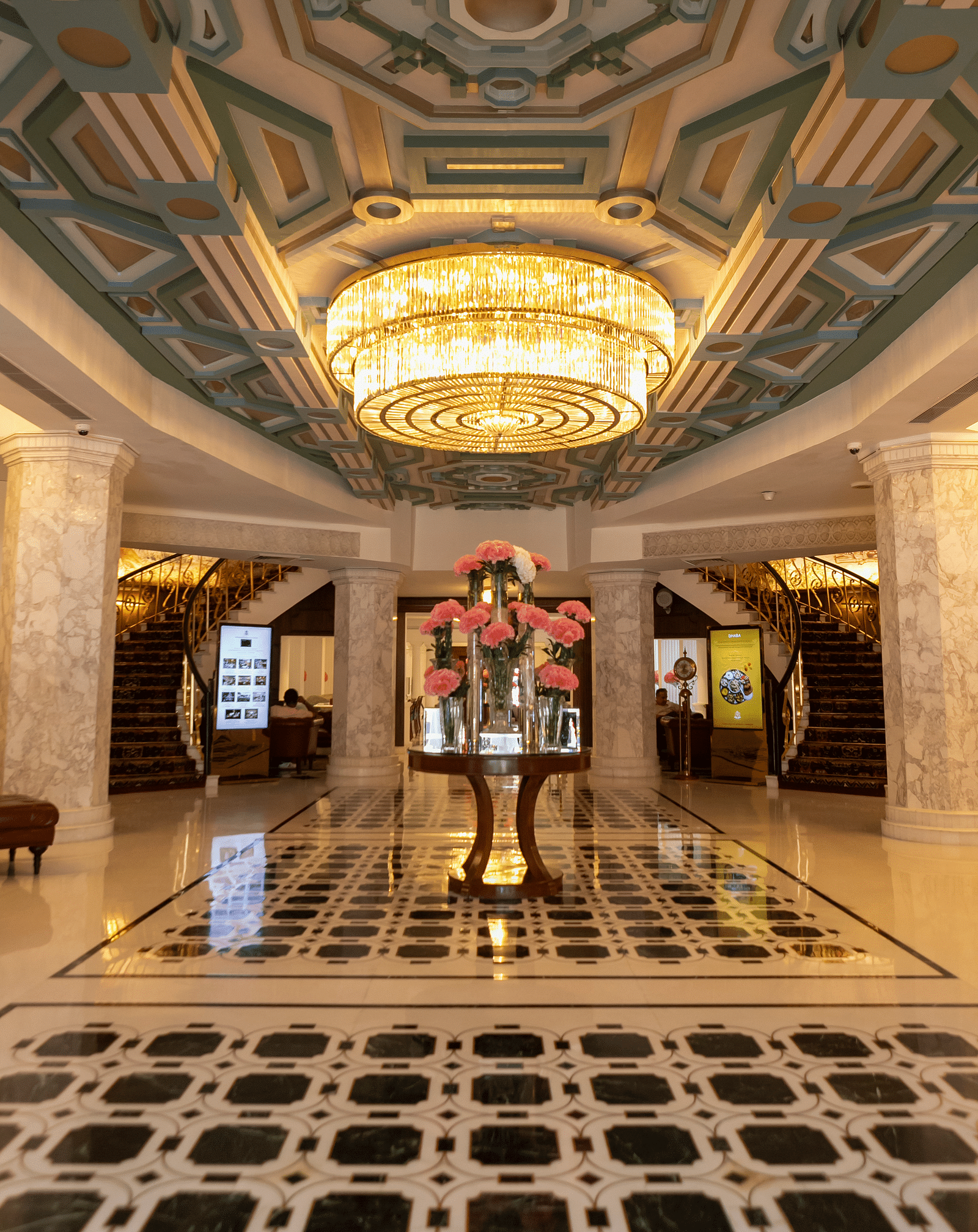 A lobby image of the The Claridges New Delhi with a chandelier hanging - Claridges Collection
