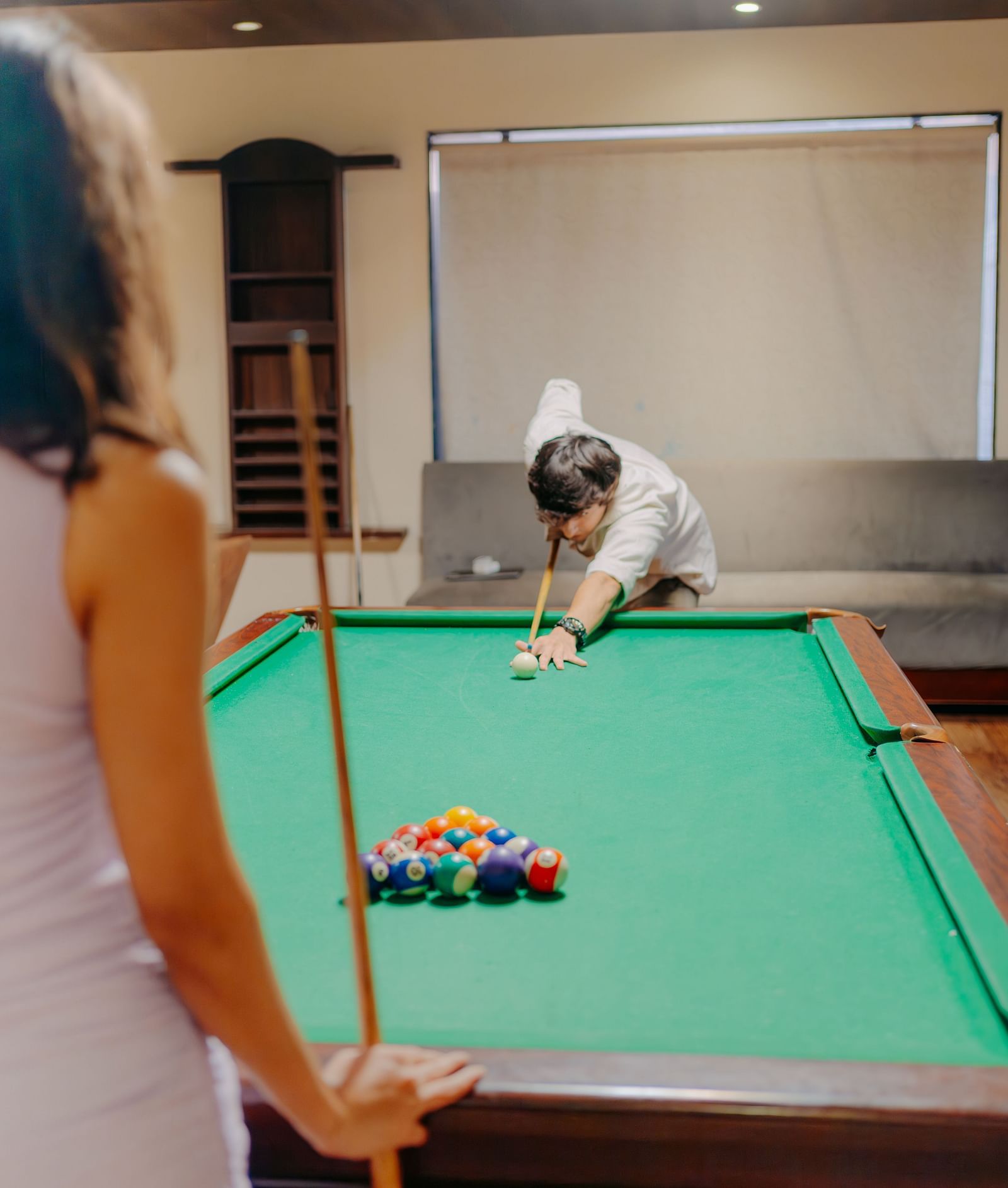 A man concentrating on his next shot in a game of snooker at Crescent Spa & Resort, Indore