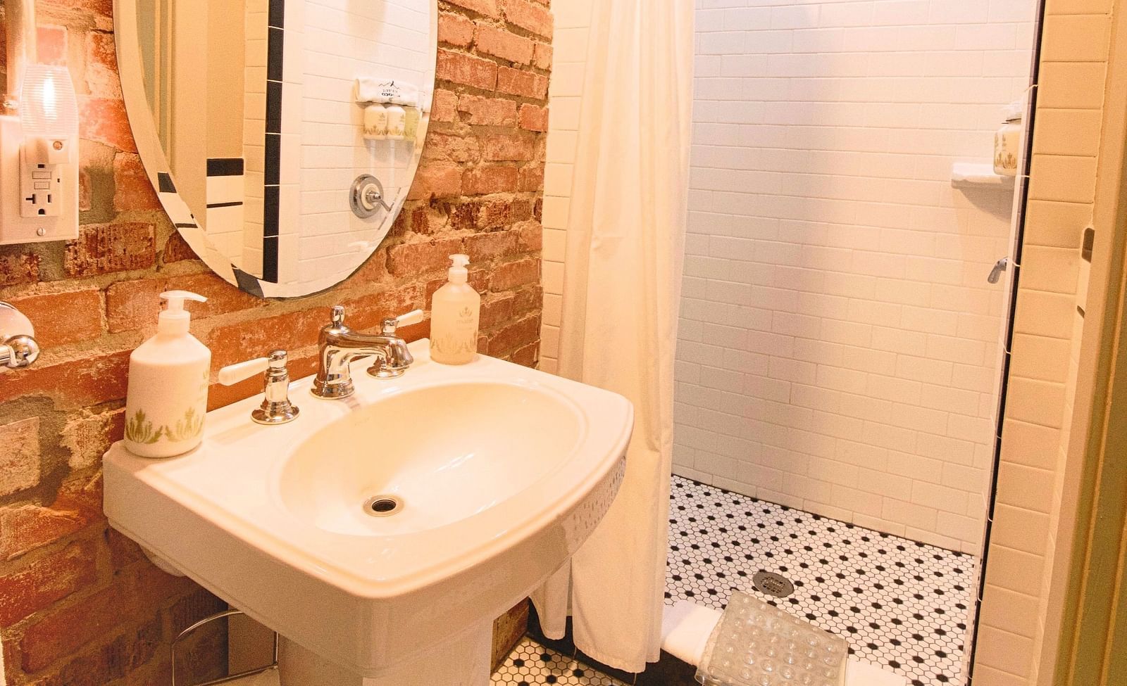 corner view image of a bathroom with a shower cubical in the corner - Historic Tapoco Lodge