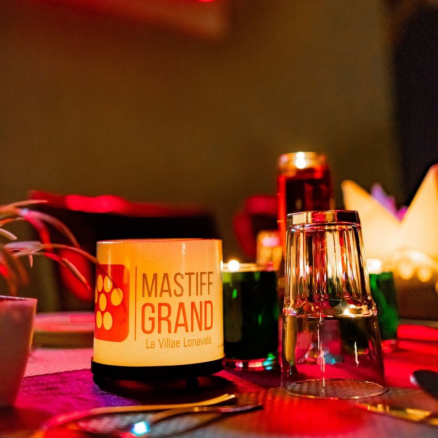 Close-up view of a table with drinks and décor, creating a relaxed restaurant atmosphere - Mastiff Grand La Villae Resort, Lonavala