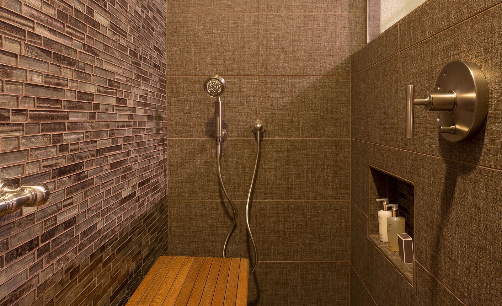 A shower area with wooden fixtures to sit on - Brewery Gulch Inn & Spa