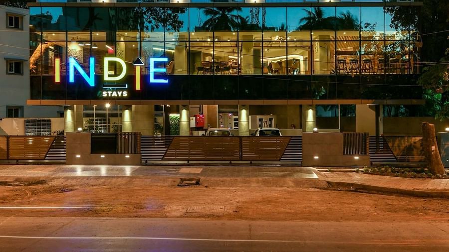 A close-up facade view of Indie Stays, BKC Kalina, illuminated against the night sky.