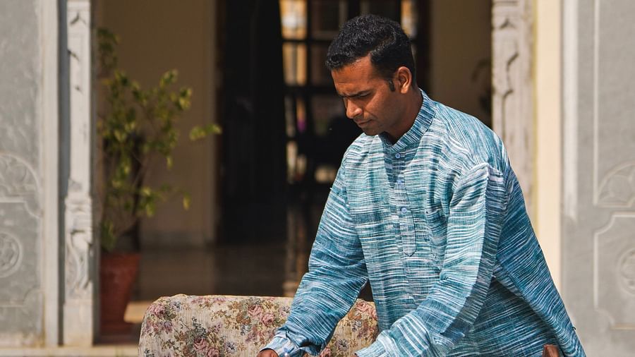 image of a person setting up the dining table at dev shree, deogarh