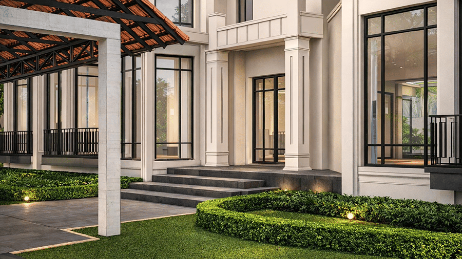 Exterior architecture of the luxury resort featuring floor-to-ceiling glass windows, tiled entrance canopy, and manicured green lawns.