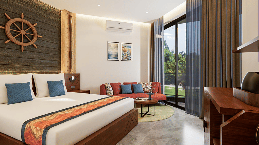 Modern sea-facing room featuring a king bed with blue-accented linens, wall-mounted air conditioner, and full-height glass balcony doors.