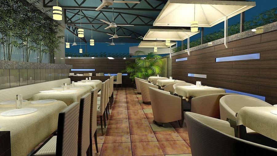 Outdoor dining area with chairs and tables arranged neatly, surrounded by plants at Oriental Aster, Mumbai.