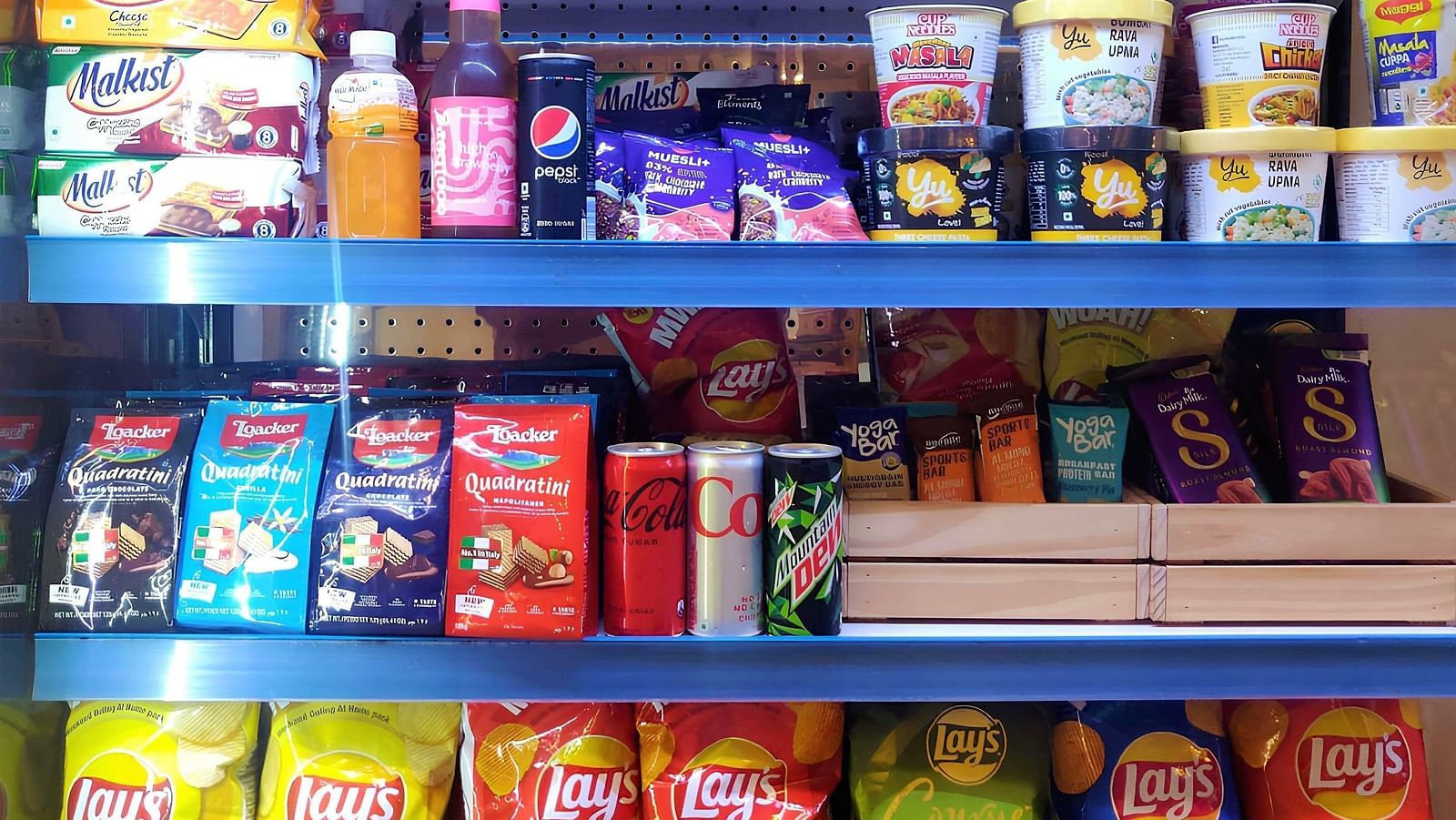 Assortments of snack items placed on shelves at Indie Stays, Chembur.