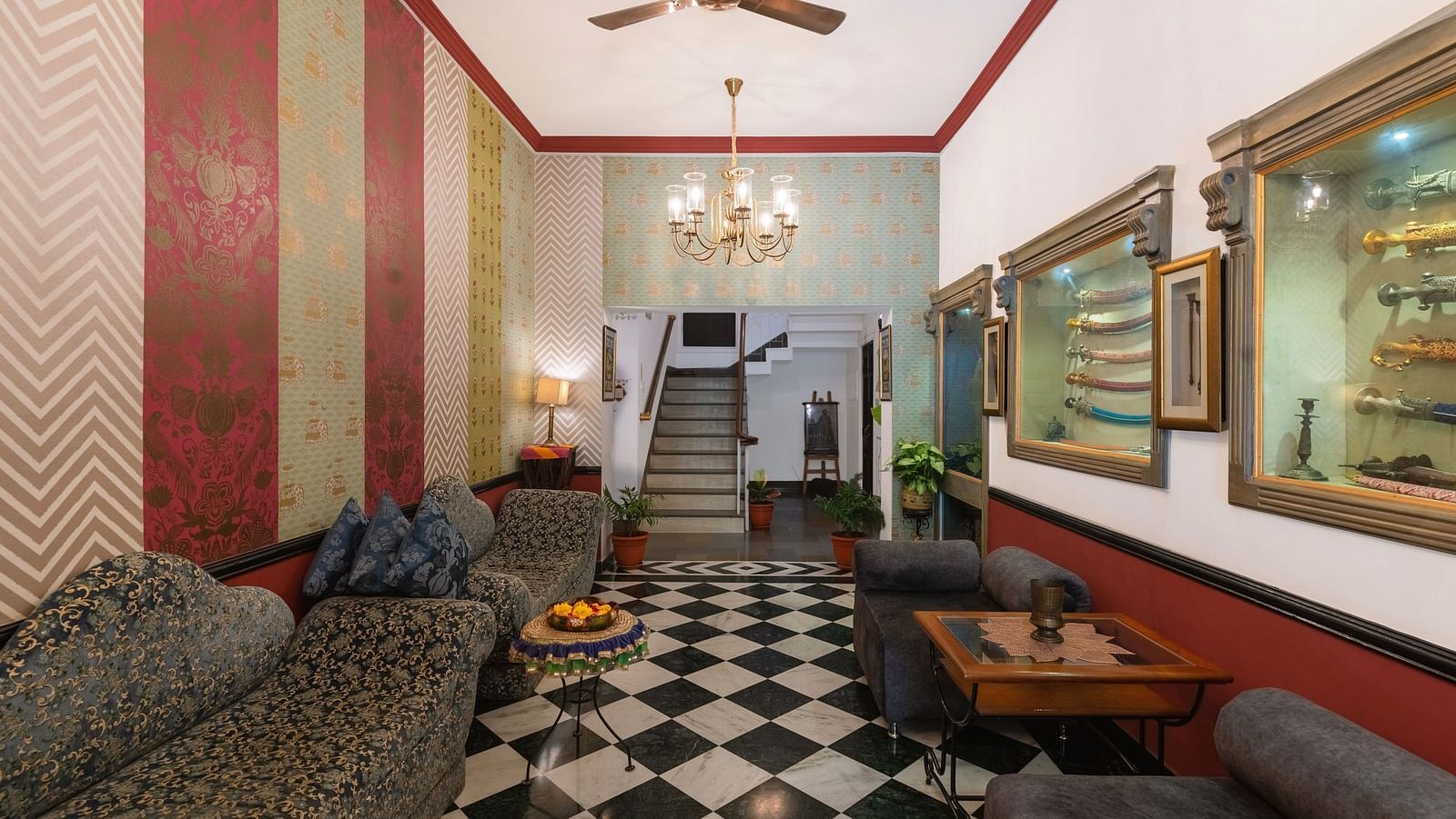 Lobby area at Panna Vilas Palace features cushioned furniture and a wooden table, illuminated by warm and welcoming lighting | Panna Vilas Udaipur