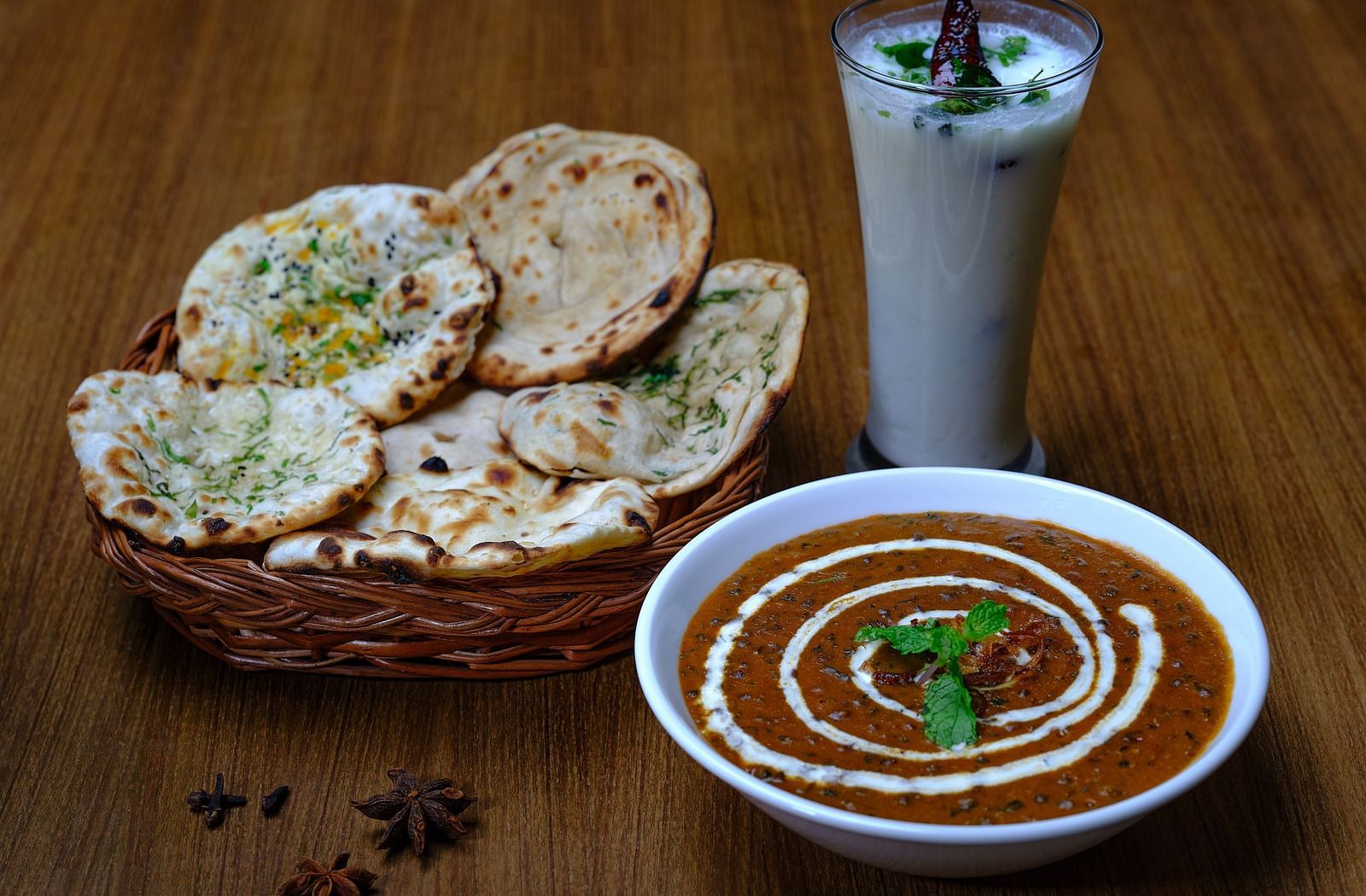 A bread basket served with a bowl of dal makhani at Essentia Premier Hotel, Chennai
