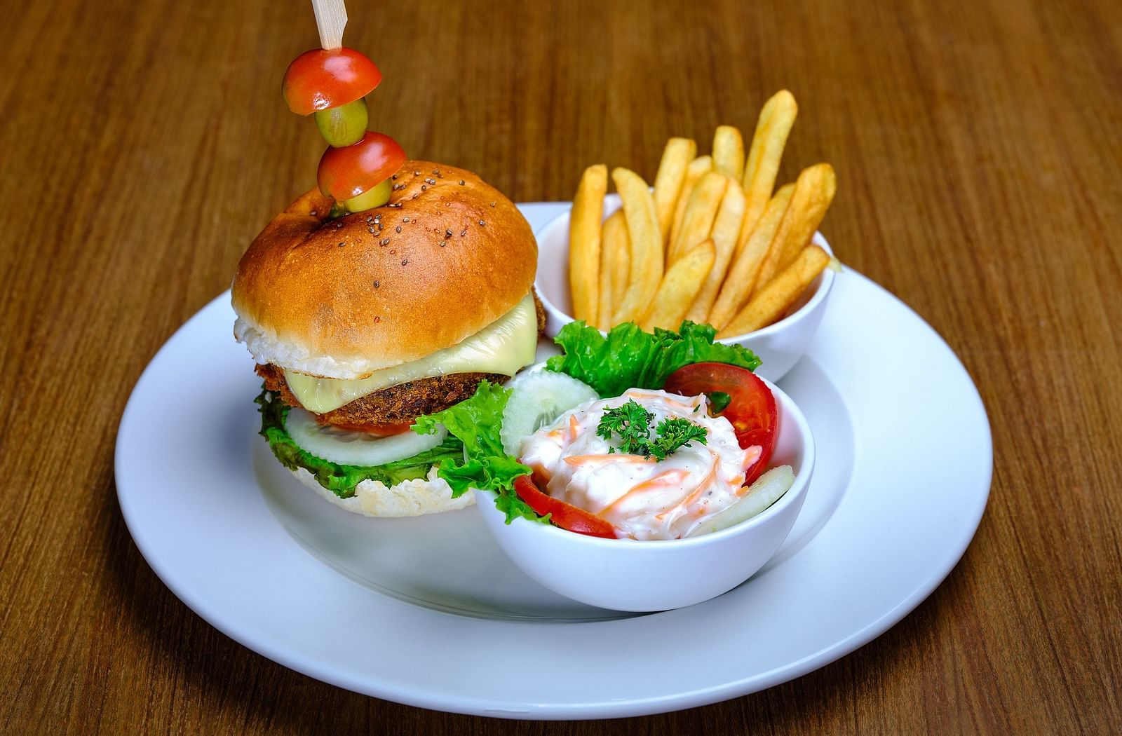 A burger served with some fries at Essentia Premier Hotel, Chennai